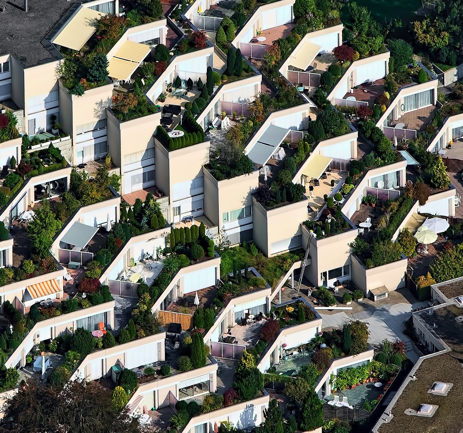 Aerial view of a terraced residential complex with planted roof gardens