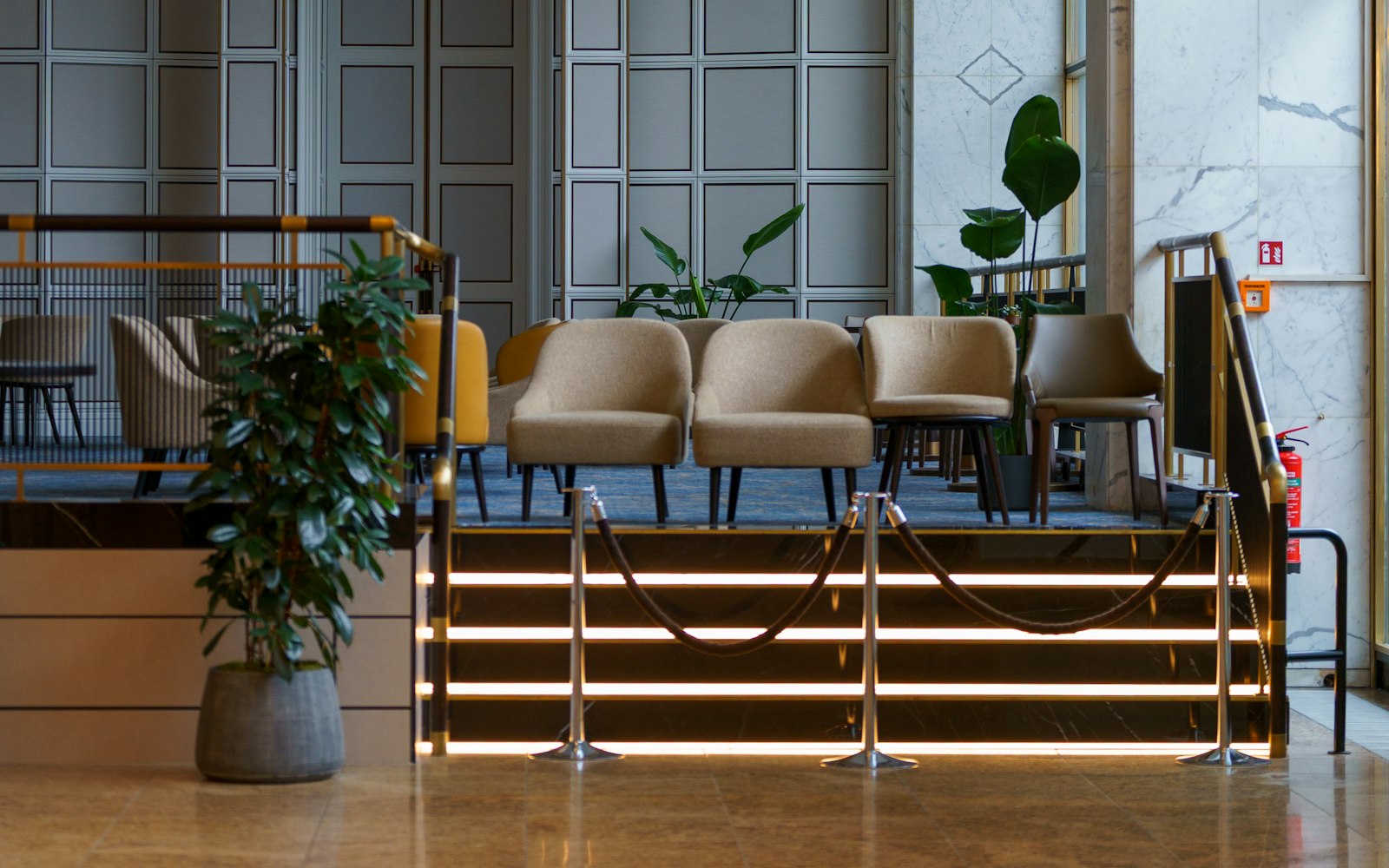 Modern hotel lobby with warm lighting and lounge seating